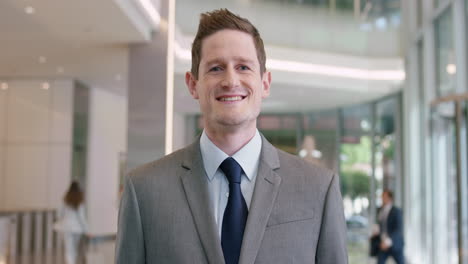 portrait of businessman at work in busy office lobby