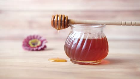 honey in a glass jar with dipper