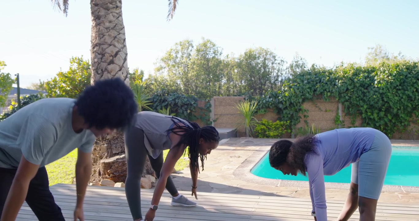 African American group in gear following woman clapping, warming up with swings and folding on deck