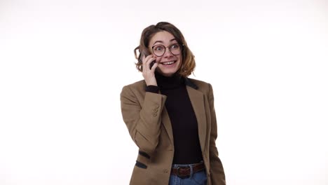 european stylish young woman receiving good news while talking on mobile phone isolated over white background and got super