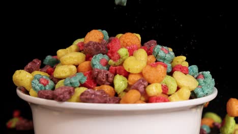 vibrant cereal pieces cascade into a white bowl against a dark backdrop, creating a dynamic and colorful visual