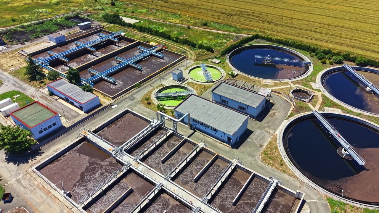 Water treatment facility operates with several large tanks for processing water at a rural location during daylight hours
