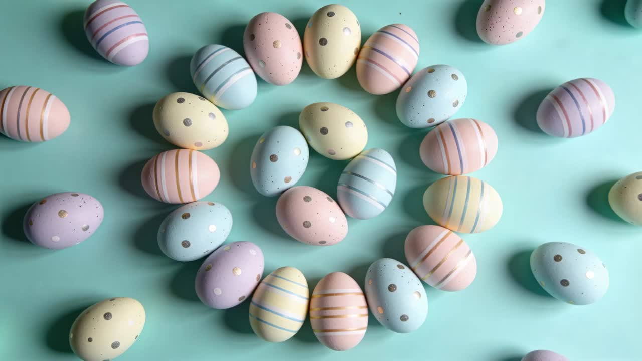 Rotating viewpoint centering on turquoise backdrop, revealing concentric pastel eggs