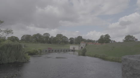 kastellet fortress in copenhagen denmark on a cloudy day looking over a pong log