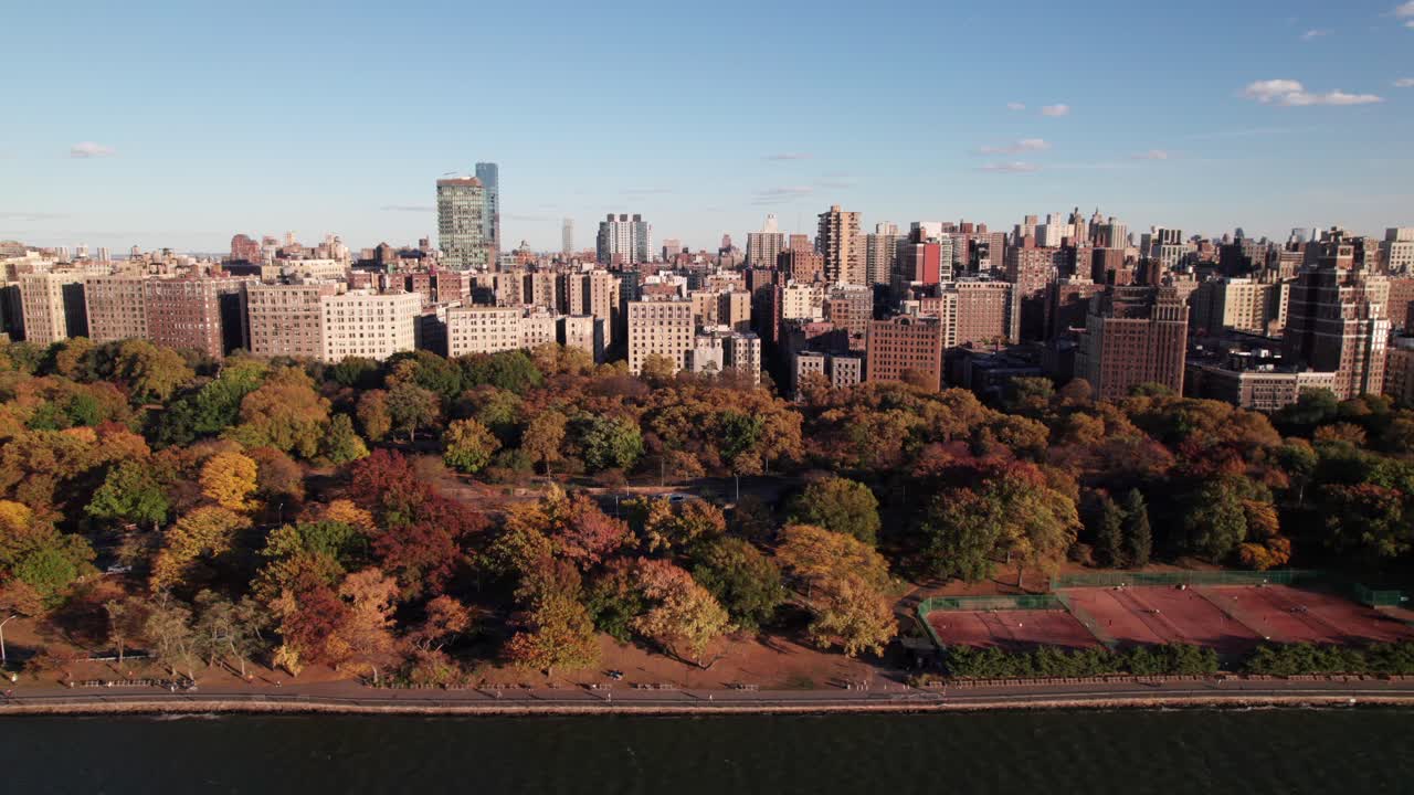 Riverside Park, NYC with tennis courts, joggers and cyclists, 4K drone shot.