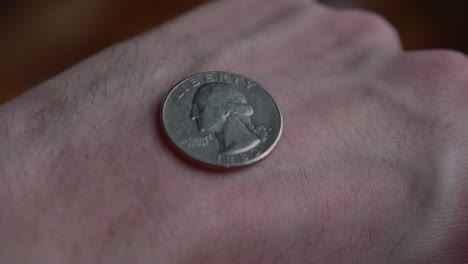 revealing coin tossed at the back of a hand with head facing up