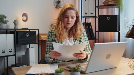 businesswoman receiving documents from boss working with financial graph calculate taxes on laptop