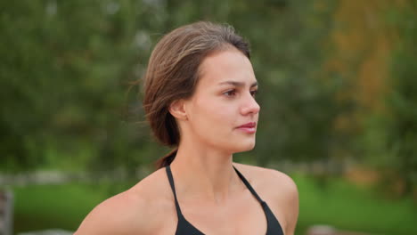close-up view of lady running outdoors, blurred background with trees, woman jogging in park, enjoying outdoor exercise, focusing on fitness, healthy lifestyle, and vitality