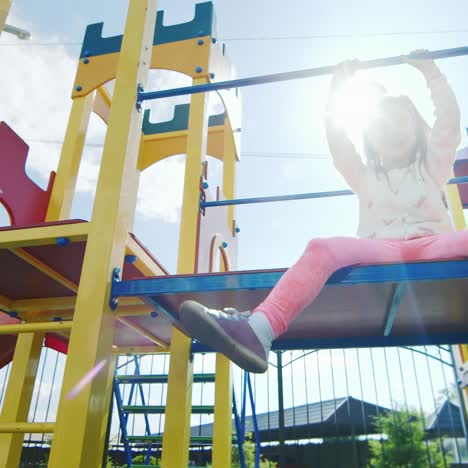 little girl on a jungle gym