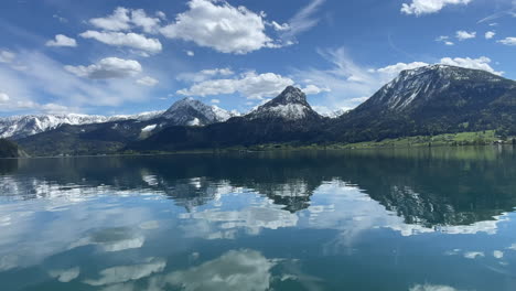 view on empty lake wolfgangsee in summer with austrian alps and mountains in background