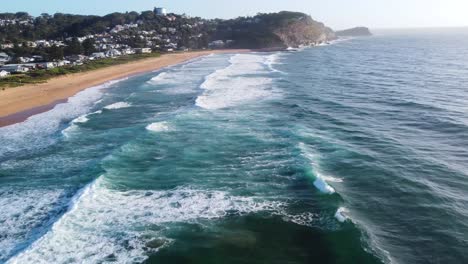 aerial drone landscape view of waves ocean beach summer in avoca cliffside central coast tourism nsw australia 4k