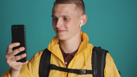 young boy doing videocall, holding bottle