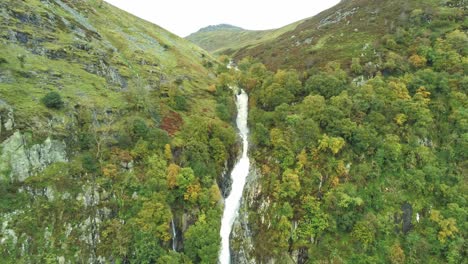 Idyllic-Snowdonia-mountain-range-Aber-falls-waterfalls-national-park-aerial-view-slow-rising