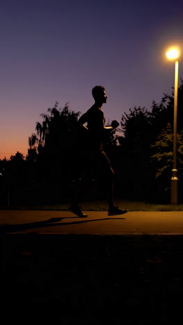 man running at sunset in a park