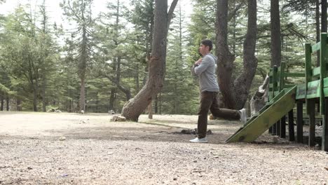 young boy sports in forest