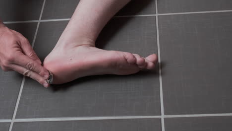 man removing corn, callus from his feet using a razor file, masculine skin care, skin disease, fungal infection, skin treatment