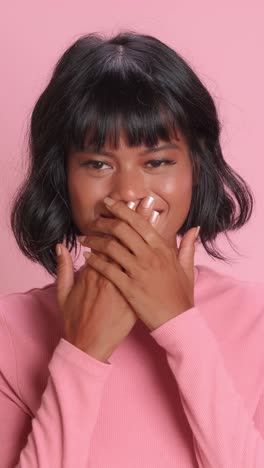 emotional moment captured with a playful expression against a pink backdrop