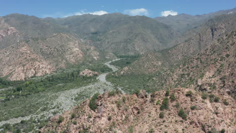 Aerial---wine-region-in-the-Andes-Mountains,-Argentina,-wide-backward-shot