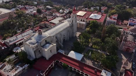 drone view of the majestic historic church in cuernavaca, showcasing its beautiful architecture, towering spires, and the lush surroundings of the vibrant city below