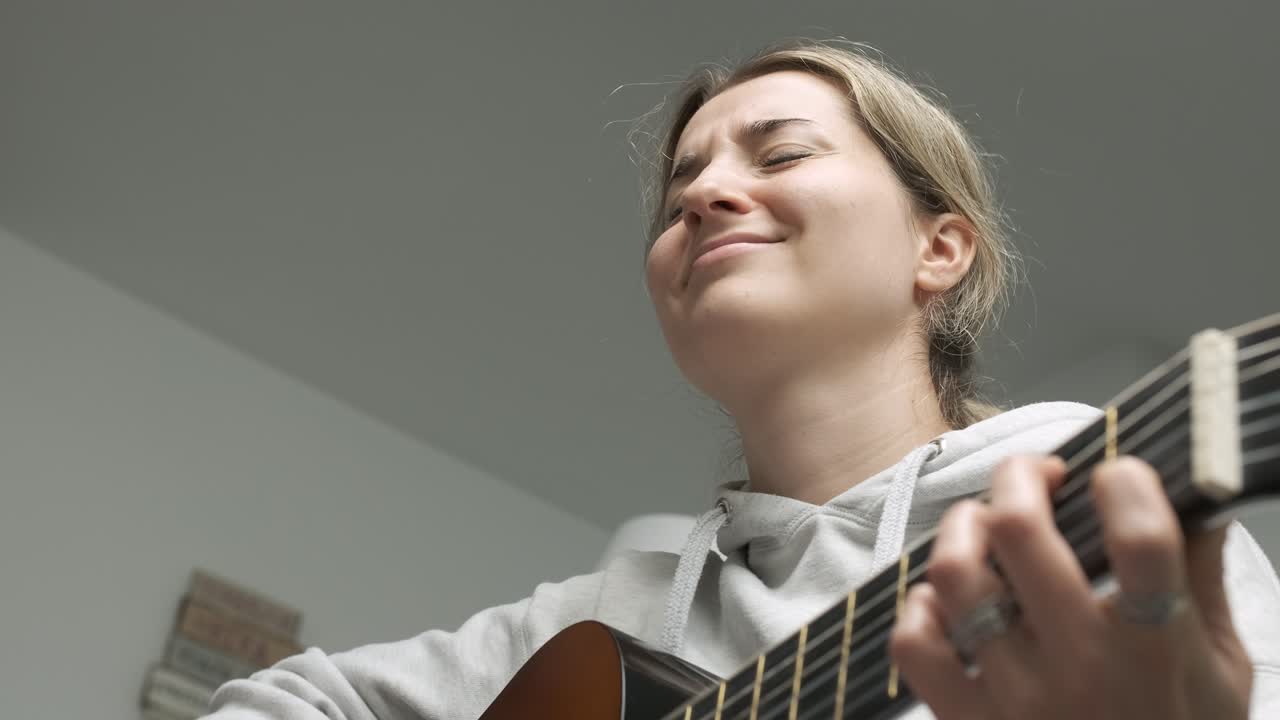 Captivating montage of a woman skillfully playing acoustic guitar