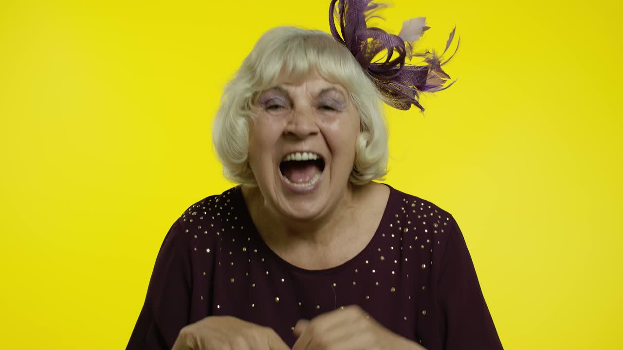 Happy senior old woman laughing out loud after hearing anecdote, funny joke, positive lifestyle