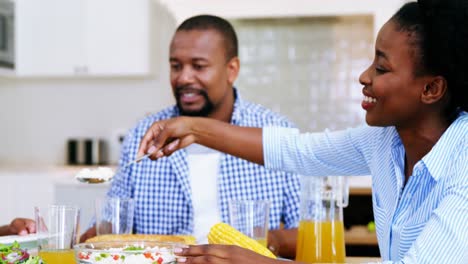 Family-having-meal-on-dinning-table-at-home