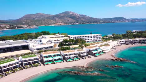 Beautiful-sea-resort-on-the-Agean-coast-of-Greece-with-Aqua-colored-waters-from-drone-view