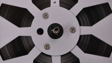 reel to reel tape recorder playing loop. rotating vintage music player close up. retro tape. spinning reels metallic color. front view