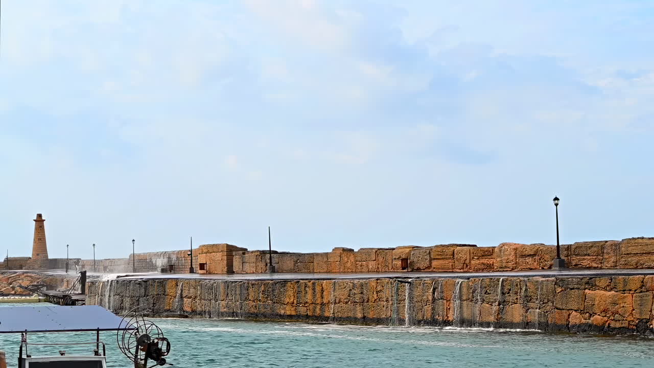 Water splashing over rocks on the shore in Kyrenia, Girne, Turkey