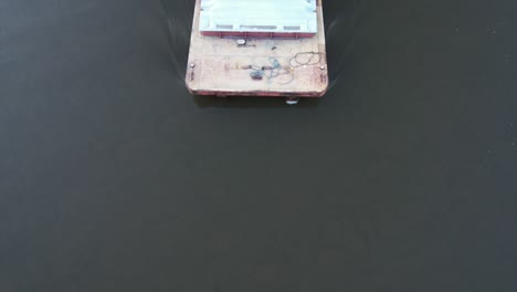 a towboat pushes a single barge south on the mississippi river