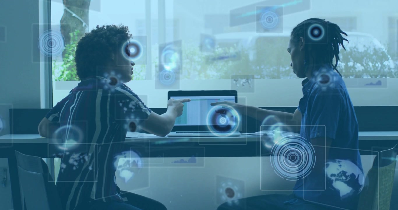 Two male peers pointing at laptop, starting tech HUD overlays sliding over window, discussing data