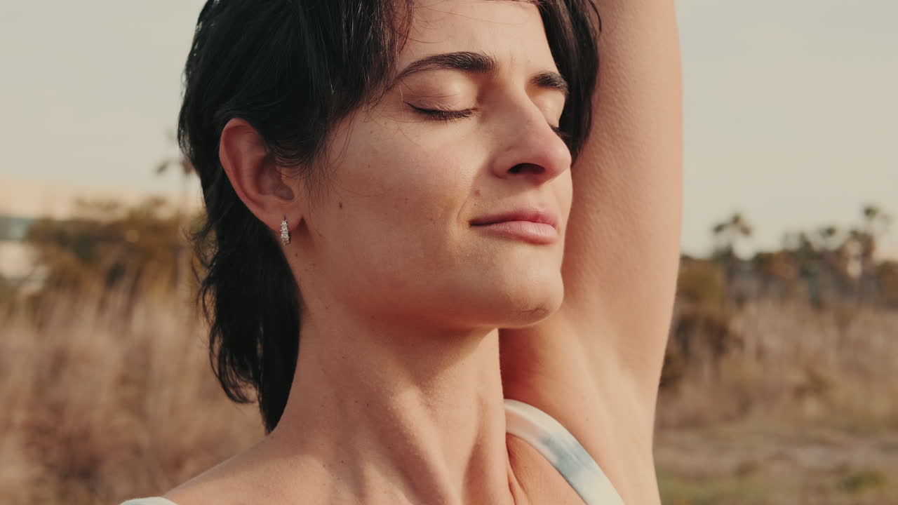 Close-up of a Peaceful Woman Meditating Outdoors at Golden Hour