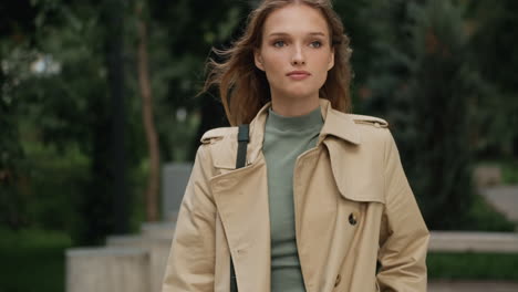 caucasian female student walking outdoors.