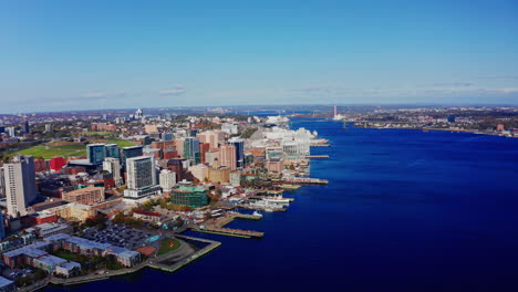 aerial drone shot over halifax downtown, nova scotia, canada.
high view of the cityscape, ocean and the urban buildings.