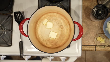 measuring and melting butter in a pot in preparation for a homemade recipe - overhead view wild rice series