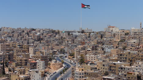 panorama view of the city of amman, jordan with flag from jabal al qal'a, the citadel of amman. 4k