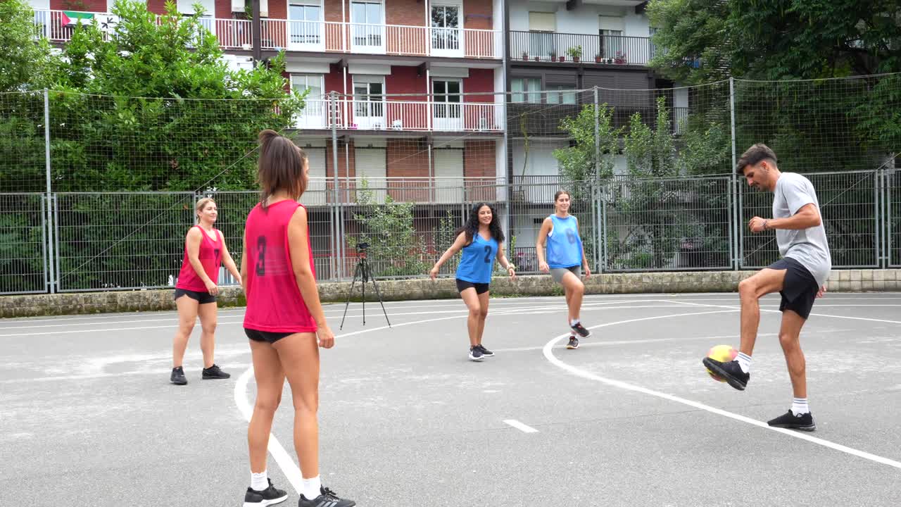 Group of people playing streetball outdoors