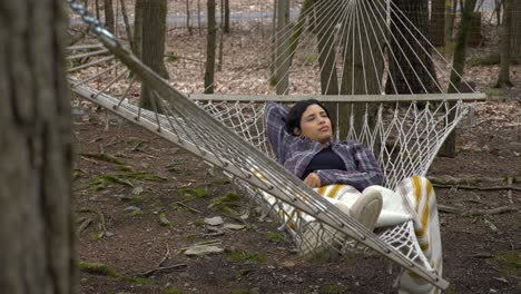 daydreaming puerto rican female swinging in woodland forest hammock carefree lifestyle