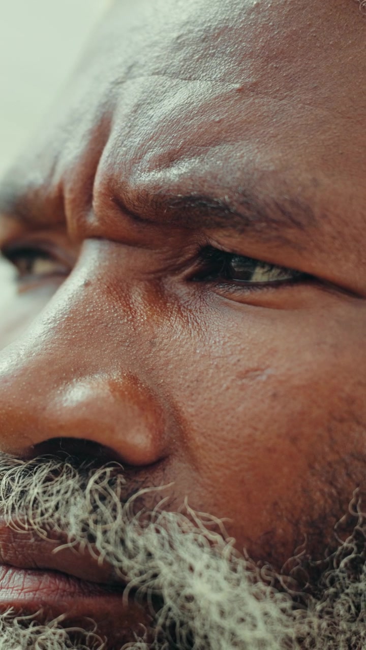 Close-up Portrait of a Thoughtful Senior Man with a Gray Beard