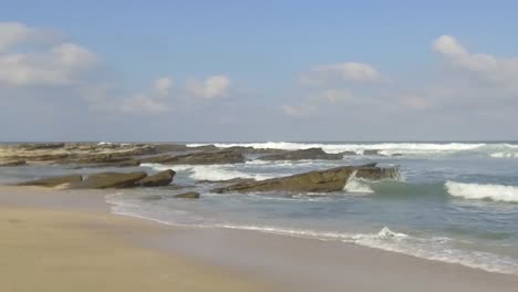 slow motion waves, rocks and sand