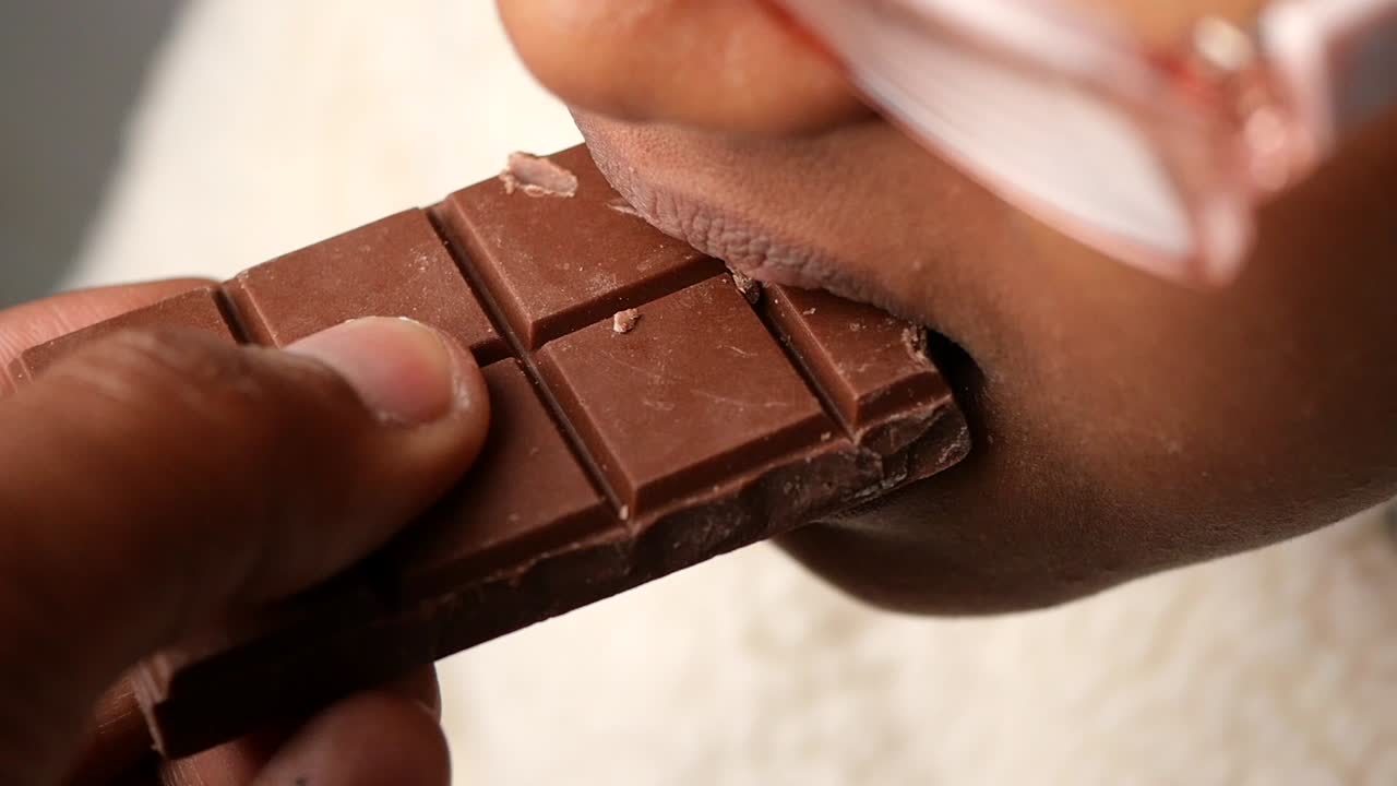 Eating a bar of chocolate