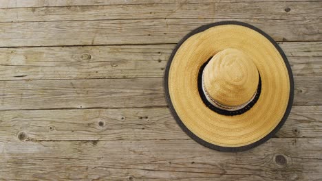 Video-of-close-up-of-hat-on-wooden-background