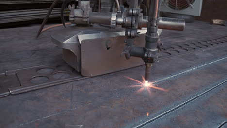 plasma cutter is cutting metal in an industrial company - high energy through heat and electrical power - special tools in the metal industry - sparks and fire in high resolution 4k shot - slow motion