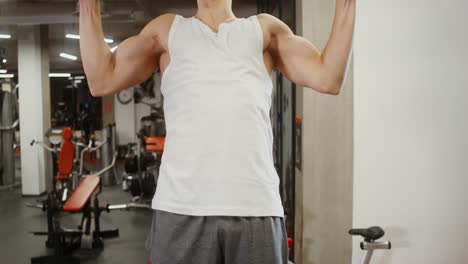 man doing pull-ups in a gym