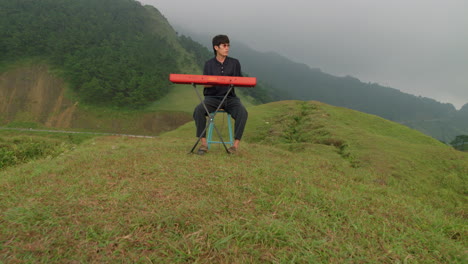 Musical-artist-playing-his-keyboard-player-outdoors