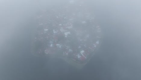 Flying-through-clouds-at-Isla-De-Flores-at-Guatemala,-aerial