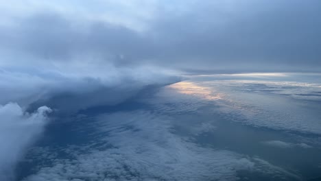 stunning view from a jet cockpit while flying near a huge cumulonimbus just after dawn