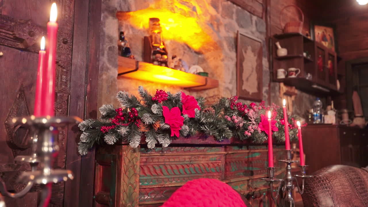 Wooden curved furniture in the living room with stone walls. Christmas decorations and dim light in the country house.