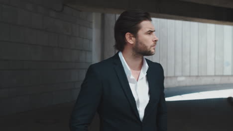 worried business man checking time on wristwatch in modern city