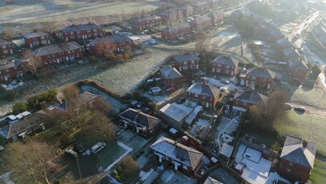 drone's-eye winter view captures dewsbury moore council estate's typical uk urban council-owned housing development with red-brick terraced homes and the industrial yorkshire